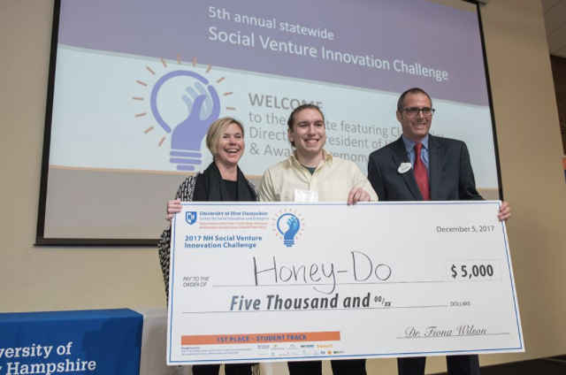 Social innovation winners pose with big check