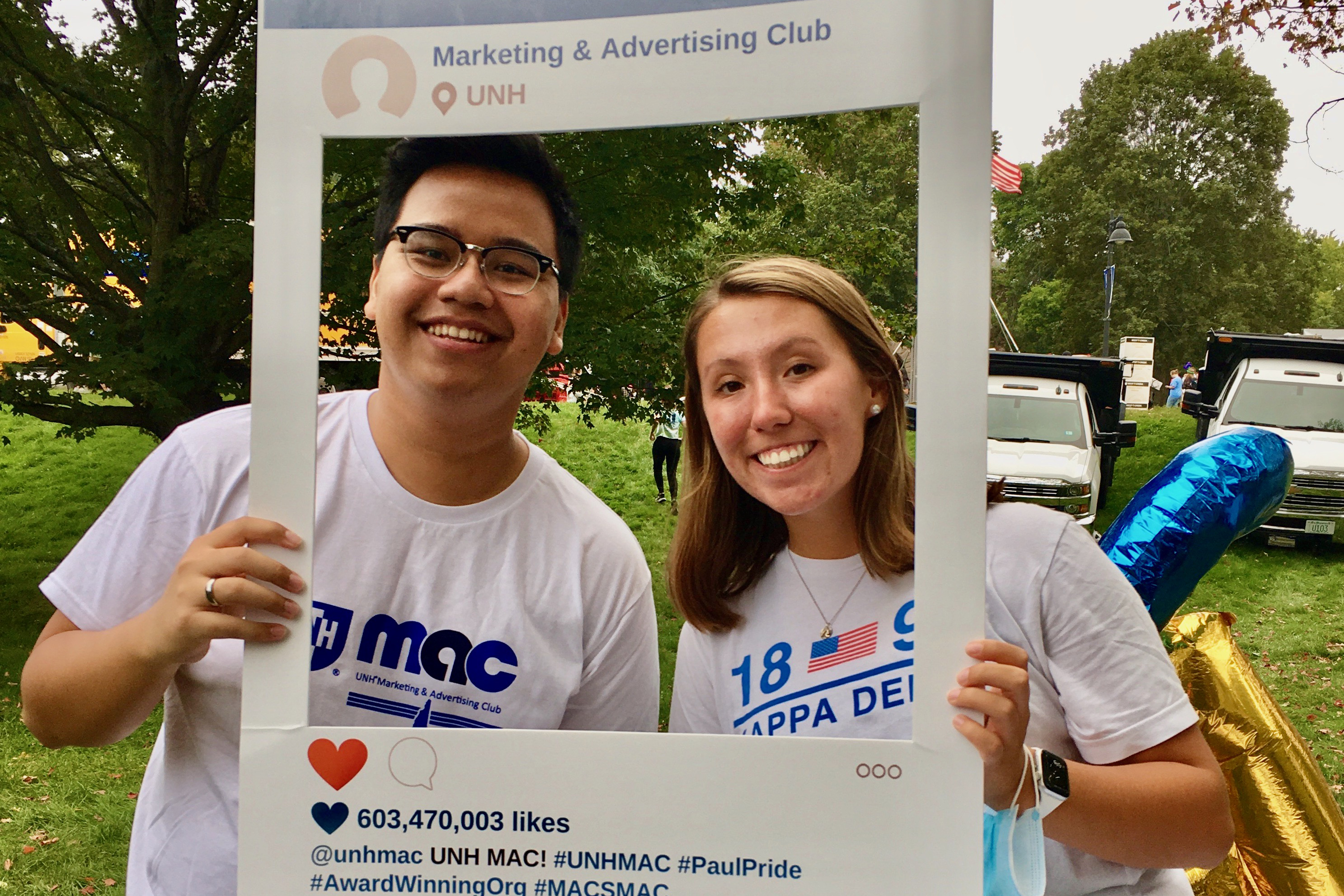 Two MAC students pose with an instagram cutout