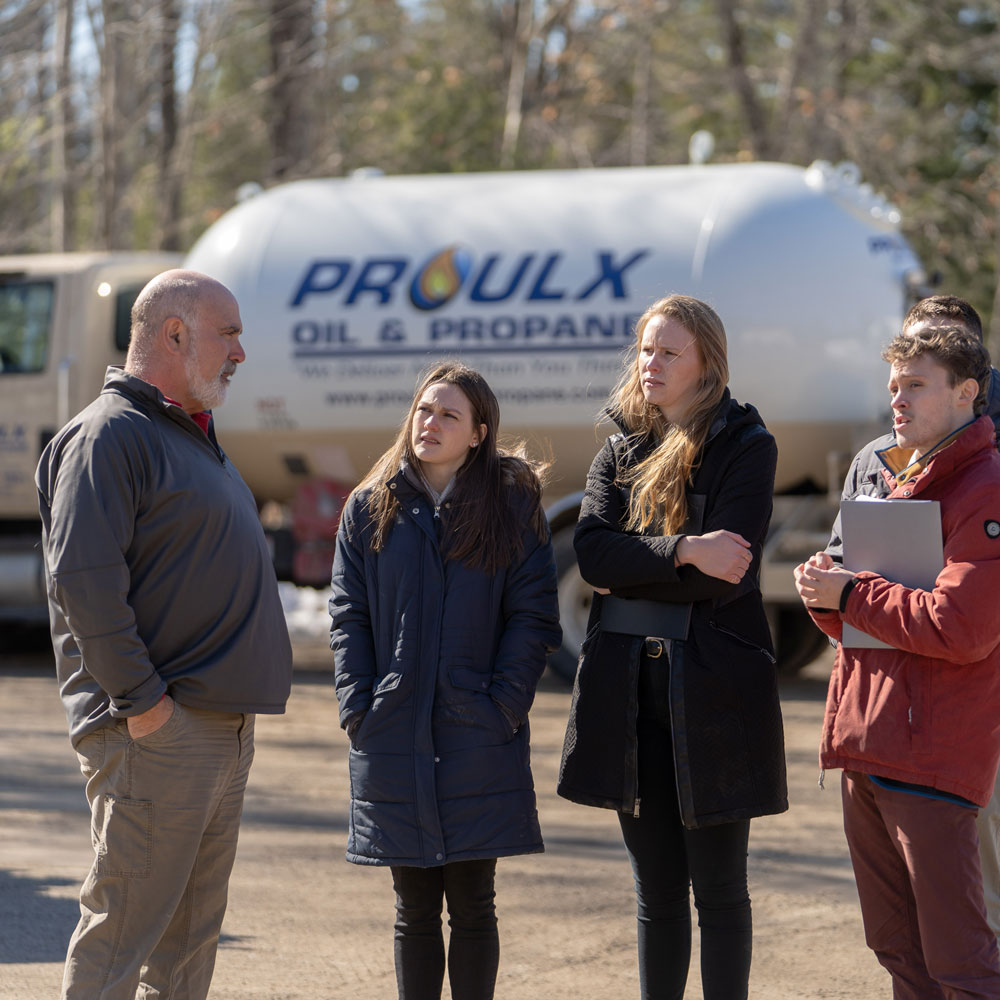 Students onsite at Proulx Oil & Propane, truck in background