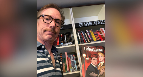 Timothy Poisson ‘92 holds his graphic novel "Liebestrasse"