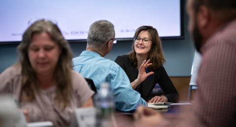 Business professional converse during training at UNH Paul College's Leadership Executive Education prograaming
