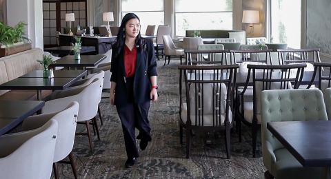 A student looks over a luxury resort dining room during a summer internship