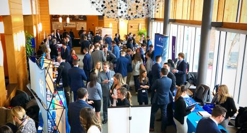 Students and employers gather in Paul College's Great Hall for a job fair