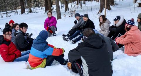 Leadership Camp group sitting in a circle in the snow