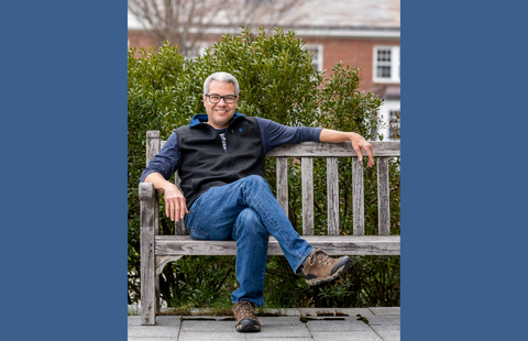 UNH's Paul College Associate Professor Bruce Pfeiffer sitting on a bench
