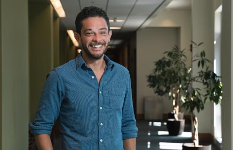 Scott Lemos stand in the hallway at the Peter T. Paul College of Business and Economics