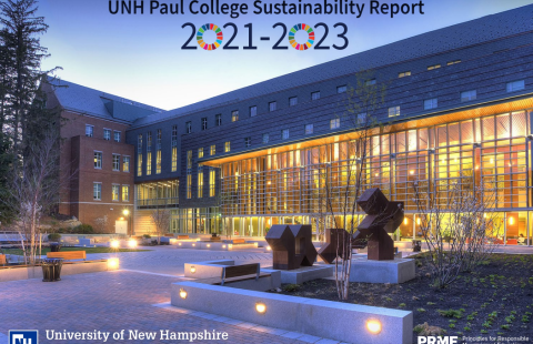 Cover of the "UNH Paul College Sustainability Report" featuring a picture of the Paul College Building from the rear Courtyard at night, with the building lit up from inside