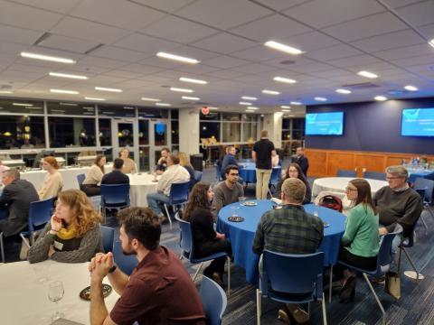 Groups of people talking at round tables