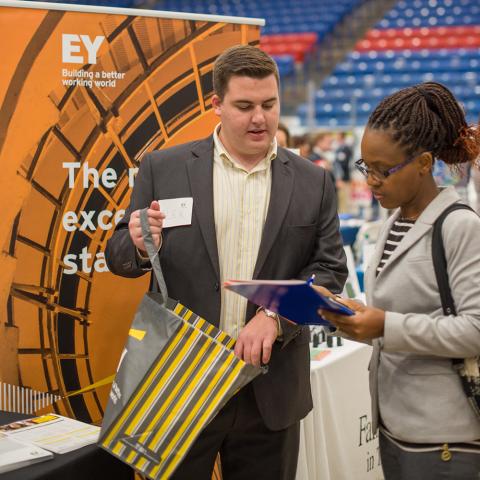 EY Recruiter talks to student at UNH Career Fair