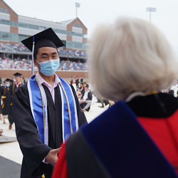 male Paul college student, 2021 graduate, with deborah merrill-sands