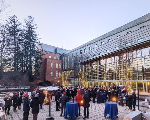 Paul college faculty and staff gather in the courtyard for a holiday party
