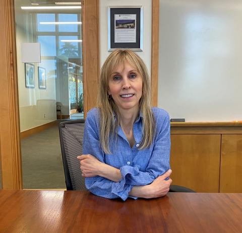 Sherri Cannon sits at conference room table at Paul College.