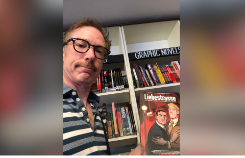 Timothy Poisson ‘92 holds his graphic novel "Liebestrasse"