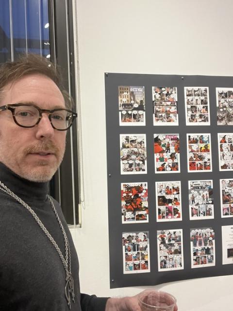 Timothy Poisson ‘92 stands with his art.