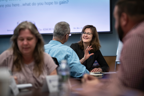 Business professional converse during training at UNH Paul College's Leadership Executive Education prograaming