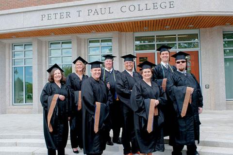 paul college alums in graduation gowns