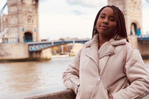 Enoska Ventura '20 A female student stands in front of london bridge.