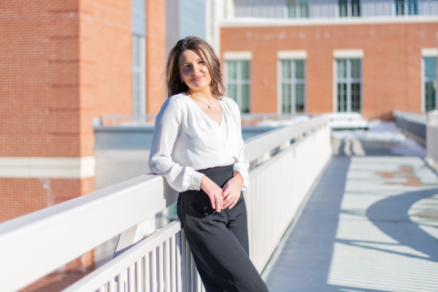 Hannah Grich '21 A female student leans against a railing and smiles at the camera.