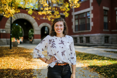 Jamie McGee '21 A female student smiles at the camera with her right arm on her left hip