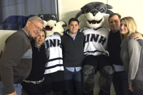 Armand Francouer ’65 COLA, Kay Ruma ’65 COLA, Colin Kelley ’12, Kevin Knarr ’91 and Emily Knarr at a UNH hockey game