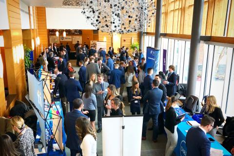 Students and employers gather in Paul College's Great Hall for a job fair