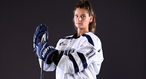 Chavonne Truter stands in full hockey gear, staring down the camera