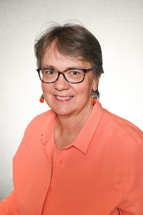 Headshot of Victoria Parker; woman with short brown hair, tortoise shell glasses, and a coral buttoned blouse